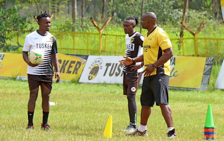 Lawrence Luvanda (L) listens to Tusker strength and conditioning coach during a recovery session