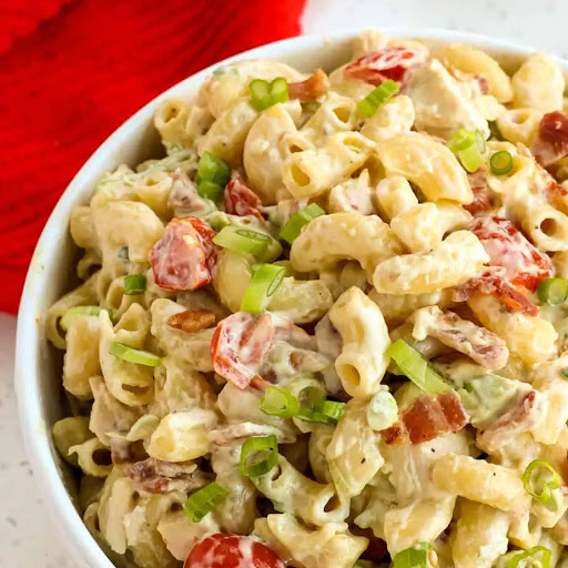 Chicken Pasta Salad Recipe combines elbow macaroni and rotisserie chicken with the flavors of crispy smoked crumbled bacon, grape tomatoes, diced avocado, and green onions, in a creamy mayonnaise dressing with a touch of honey, garlic, and mustard.