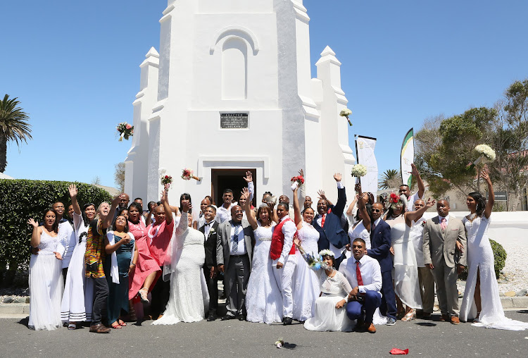 Home affairs minister Aaron Motsoaledi, centre, celebrates with 19 couples who got married on Robben Island on Valentine's Day last year.