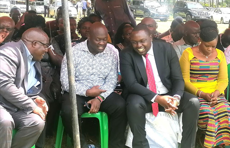 Kitutu Chache South and Kitutu Chache North Mps Anthony Kibagendi and Japhet Nyakundi confer at a burial in Nyaore Polytechnic grounds on Monday. The leaders and Senator Richard Onyonka have been trading barbs with Governor Arati over staff audit and recruitment of senior staff to the administration.