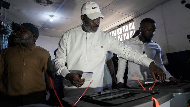 Leader of Liberia's ruling party Coalition for Democratic Change(CDC), President and former soccer player George Weah, prepares to cast his vote during the presidential elections in Monrovia, Liberia October 10, 2023.