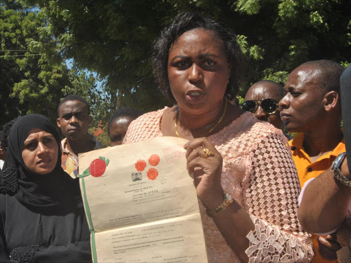 Malindi MP Aisha Jumwa with a title belonging to Swaleh Abdulkhadir, whose property was demolished on the Ngalla Estate on Monday/