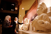 Visitors look at restored sculptures in an exhibition, at the Opera house in Damascus, Syria October 3, 2018. 