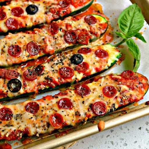 Learn how to make fun and easy low carb Pizza Stuffed Zucchini Boats. They taste so amazing that you won’t even miss the sluggish carbs.