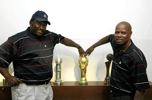 Jomo Sono and Phil Masinga with the World Cup trophy during its display at Fifa House in 2010.