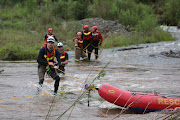 Search and rescue teams retrieve the body of a man, on January 26 2021, on the Blyde River near Pilgrims Rest, Mpumalanga, after a two day search. 