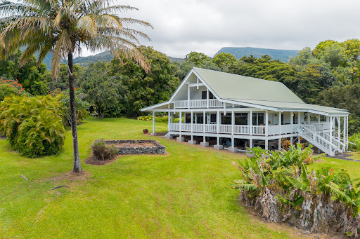 White stilt house tropical garden in this luxury house for sale in Hana ($2,100,000)