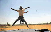 OBLIVIOUS: Children play on a trampoline in Thembelihle, an informal settlement built on dolomitic land near Lenasia, south of Johannesburg. Residents are divided over whether or not they should move from the area.