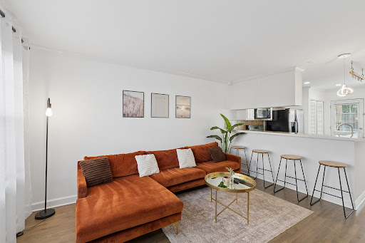 Orange sectional sofa, golden coffee table - Buy this luxury property in Atlanta, 2 bedrooms