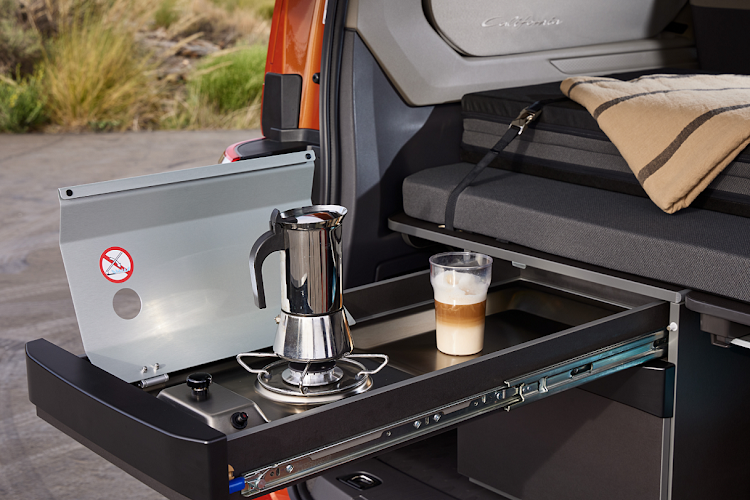 The kitchen with a single-burner gas cooker and cutlery drawer pops out the back.