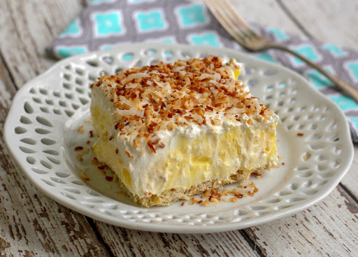 A slice of coconut cream pie deluxe on a plate.