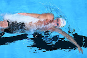 Pieter Coetzé in action in the 100m backstroke heats at the world championships in Doha on Monday. 