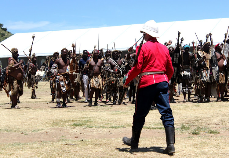 Gavin Slater dressed as a British soldier walks towards the Zulu regiments before the start of the re-enactment of the Battle of Isandlwana between Zulu regiments and British soldiers in 1879. Images:Nqubeko Mbhele