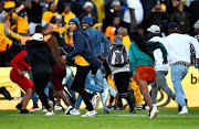 Kaizer Chiefs fans storms the pitch during the MTN8, quarterfinal match against Stellenbosch FC at Danie Craven Stadium on August 28 in Stellenbosch.