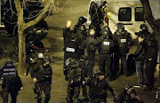 Police secure the area close Jules Ferry Square in central Paris, on November 13, 2015. AFP PHOTO / KENZO TRIBOUILLARD