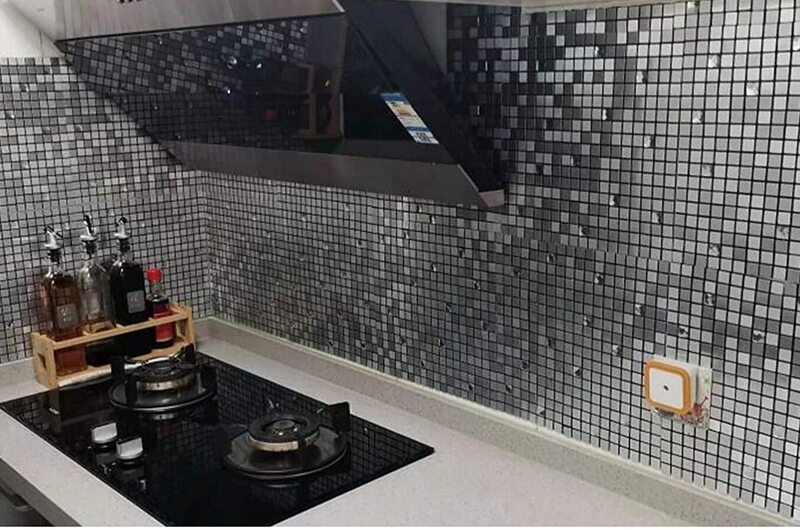 metallic glass and silver square tile backsplash 