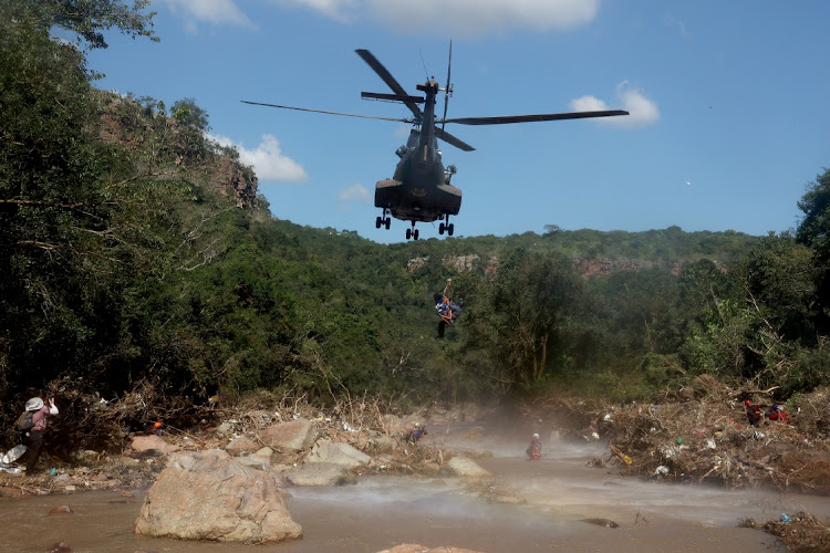 The body of a child is lifted into an SANDF helicopter at the foot of uMzinyathi Falls, north of Durban.