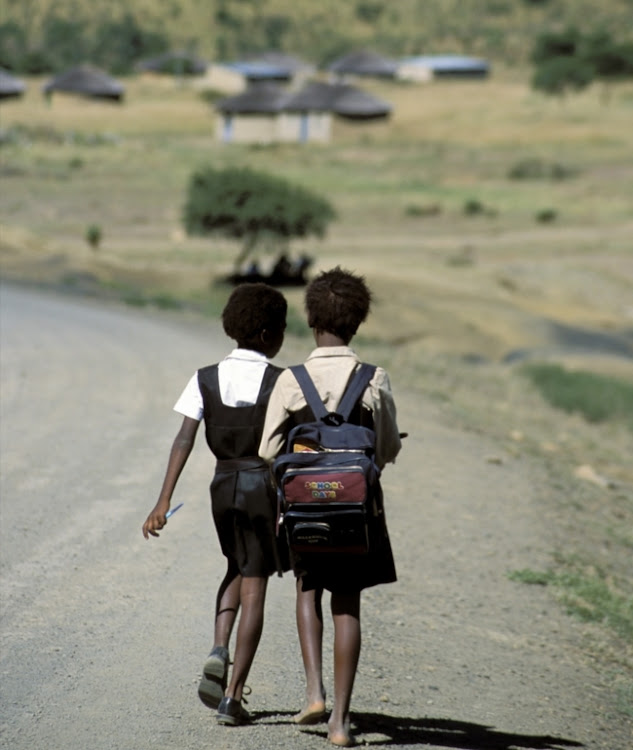 Schoolchildren walking along gravel road to/from school in Kwa-Zulu Natal.