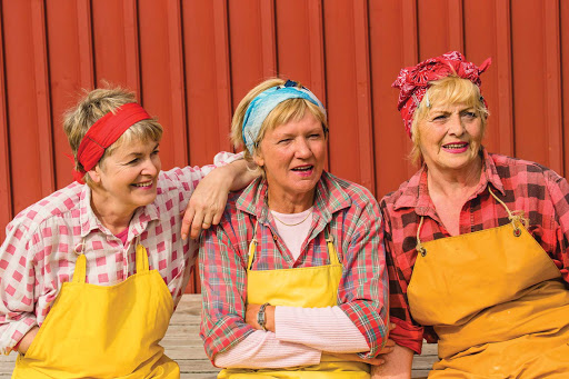 A group of women dress up as herring girls at the Herring Era Museum in Siglufjörður, Iceland on a Lindblad Expeditions visit.