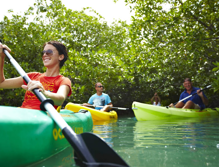 Visitors take ocean kayaks out to sea along the coast of Bonaire. 