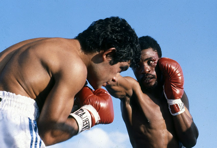 Peter Mathebula of South Africa, trades blows with Santos Laciar of Argentina during their bout in Soweto, South Africa.