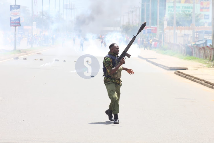 Police officer holding a tear gas gun in Kisumu during mass protest on March 30,2023.