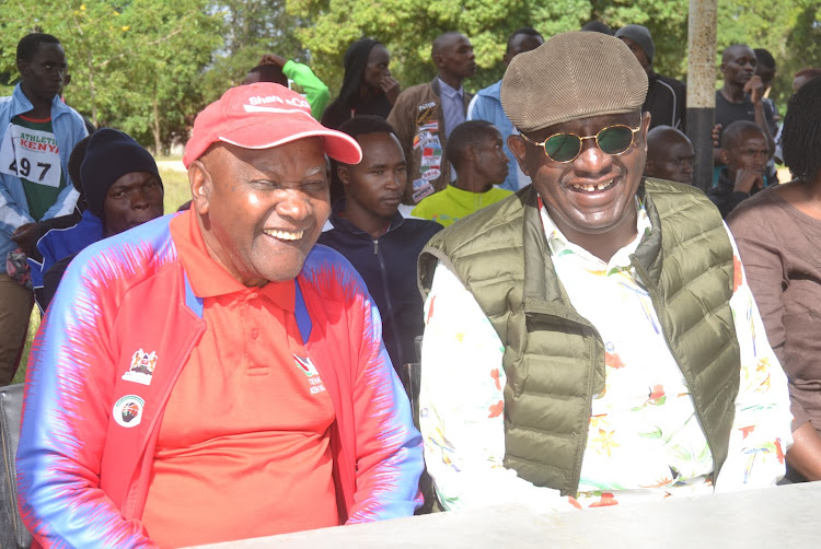 AK Southern branch chairman Paul Mutwii and enviromentalist Isaac Kalua share a light moment