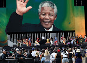 The face of former president Nelson Mandela is projected on the screen during the performance of singer Usher during the Global Citizen Festival on Sunday