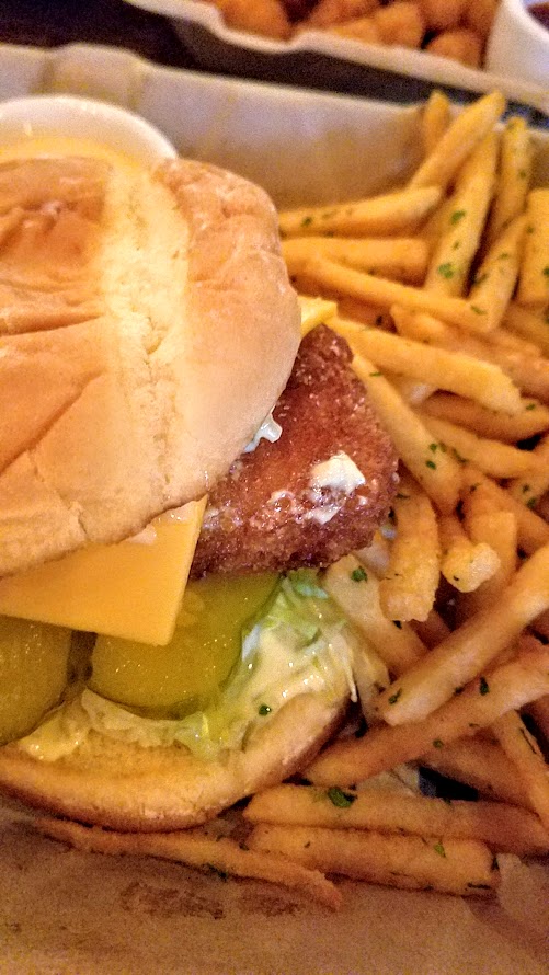 Chicken Fried Fish Sandwich with Tartar Sauce, Pickles, Lettuce, Potato Bun, Fast Food Fries and Spicy Dipping Sauce, optional American Cheese from Shipwreck PDX at Taqueria Nueve