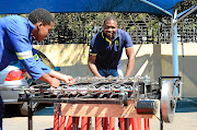 Clement Mokoenene, right,  and a member of his team test their new energy harvesting system that can generate electricity enough to light up an RDP house using traffic.  /  Mduduzi Ndzingi