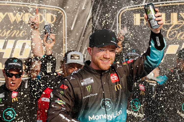 Tyler Reddick celebrates in victory lane after winning the NASCAR Cup Series Hollywood Casino 400 at Kansas Speedway on September 10 2023 in Kansas City, Kansas.