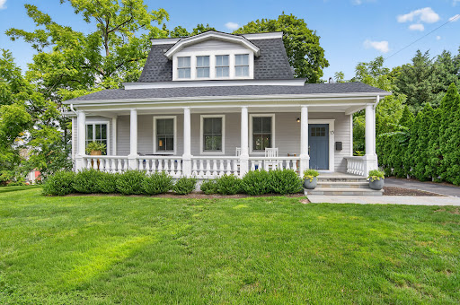 Gray house with porch and garden in this luxury property for rent in Port Washington ($10,000)