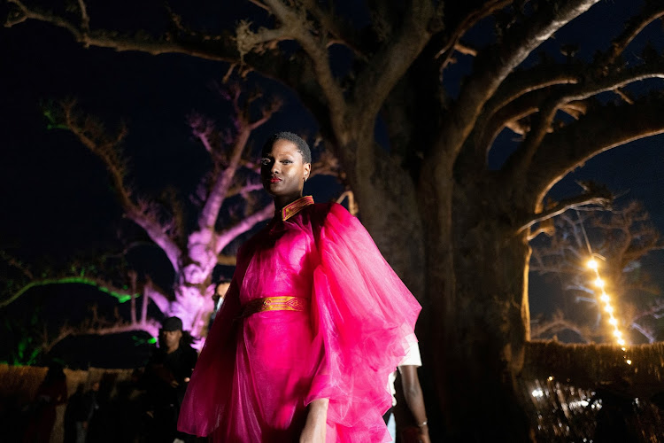 A model waits backstage during the 19th annual Dakar Fashion Week, at the Baobad forest, in Mbour, Senegal.