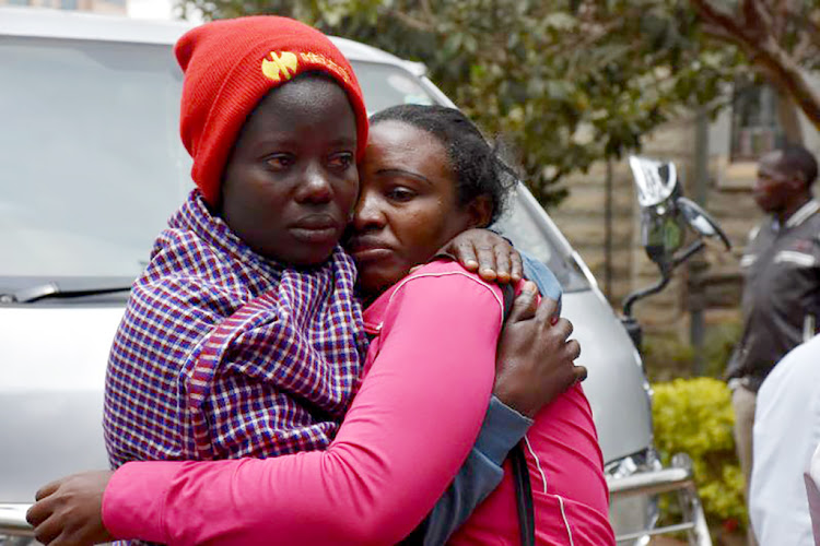 Regina Wanjiru (right) is comforted after viewing her son's body at City Mortuary on Thursday, September 26