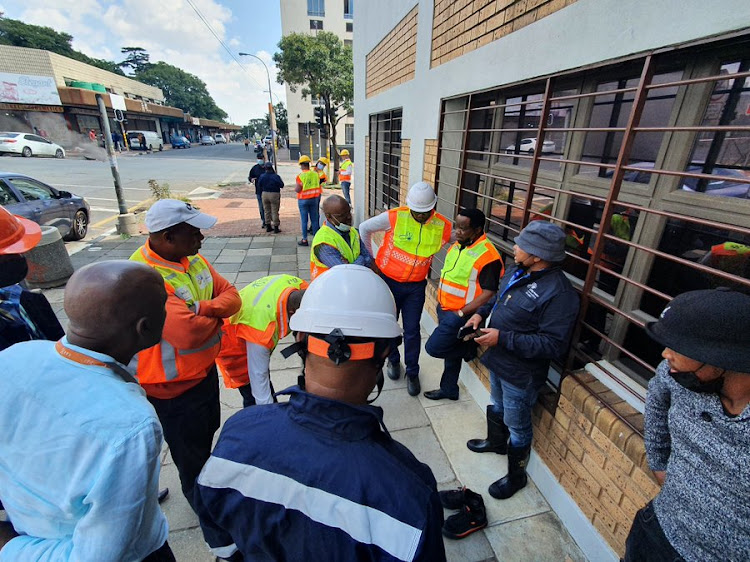 City Power managers, engineers and technicians gather above the tunnel on Ntemi Piliso and Anderson streets. The underground tunnels tripped two main lines to Central and Selby substation.