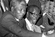 OLD FRIENDS  Tambo, with Nelson Mandela next to him, receives  a gift