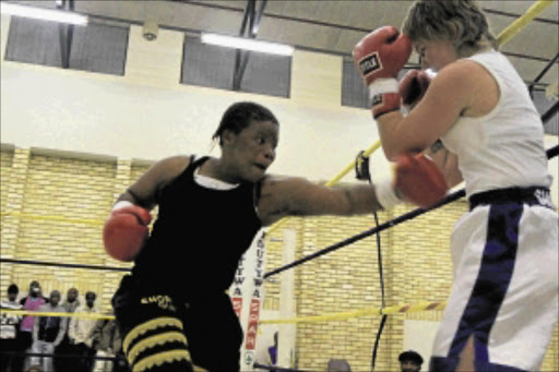 LOCAL FAVOURITE: Champion Rita Mrwebi, left, had too much power for challenger Shayvonne Pattison