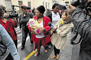 MOTHER'S RELIEF: Nomveliso Semsem with her baby Baxolile outside the Cape Town Magistrate's Court yesterday. The baby was found on Saturday after he was taken from Groote Schuur Hospital on New Year's Day. Ntombekhaya Mgqaza appeared in court on child-kidnapping charges