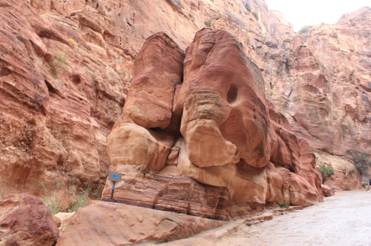 A large rock formation that somewhat resembles an elephant at the entrance to Petra, Jordan. 