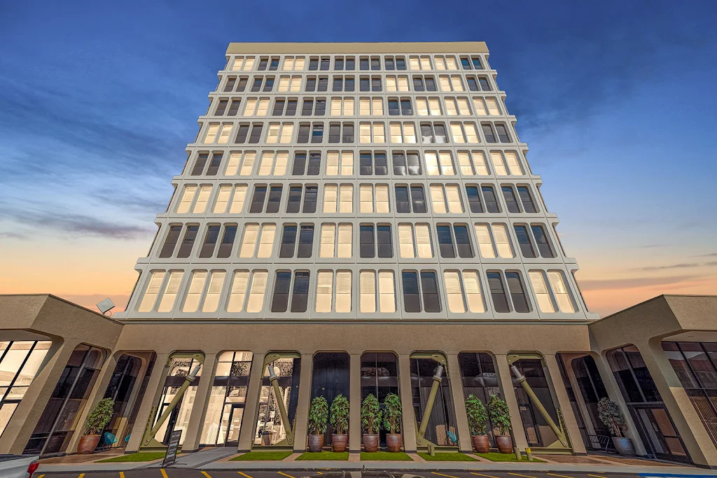 888 on Main's high-rise apartment building with floor-to-ceiling windows at dusk