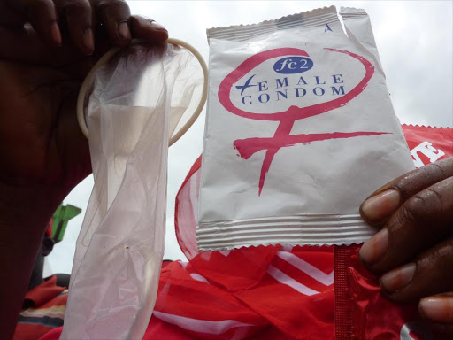 A health worker displays a female condom at a past training. /FILE