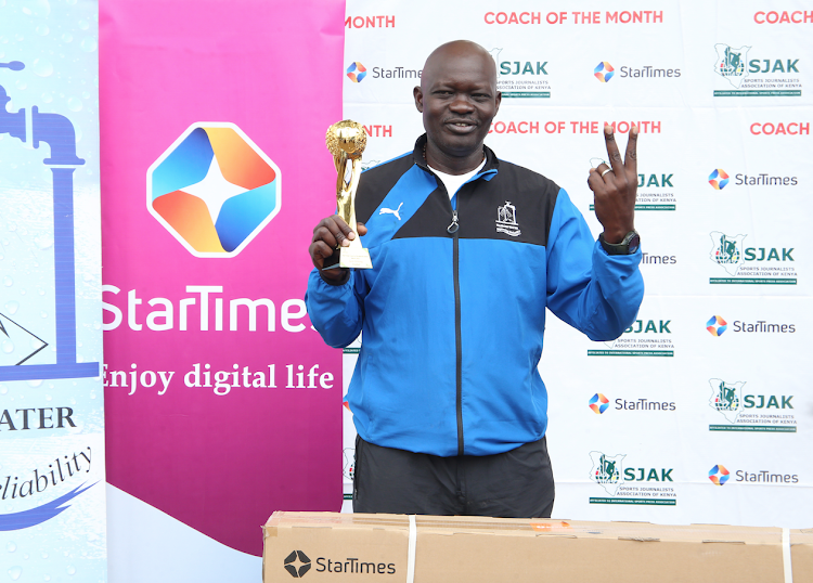 Water Queens' Jack Ochieng displays his trophy after winning Star Times Coach of the Month award