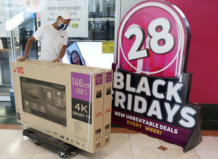 Stores say they are expecting good sales extending into the Christmas shopping season on the back of the November 26 Black Friday promotion. Here, a shopper leaves a store in Canal Walk, Cape Town, during last year's quiet, pandemic-hit Black Friday. File photo.