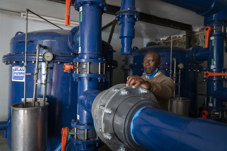 Abel Mokoena is seen in the basement below the university’s pool where the massive heating pumps and filters are located.