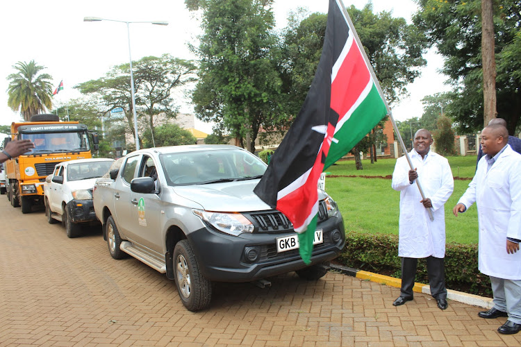 Nyeri governor Mutahi Kahiga and his Agriculture CEC James Wachihi flags off a consignment of certified potato seeds outside the governor’s office on Friday.