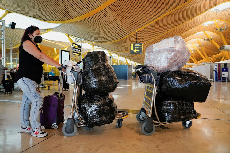 Marilys Colarte queues to check in two trolleys full of medical supplies to Cuba at Adolfo Suarez Barajas airport in Madrid August 4, 2021.