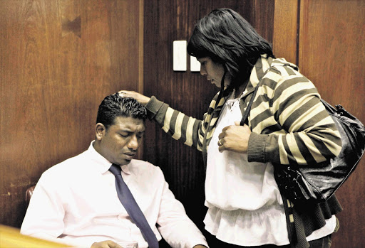 Matthew Naidoo comforted by a family member at the Durban High Court Picture: TEBOGO LETSIE