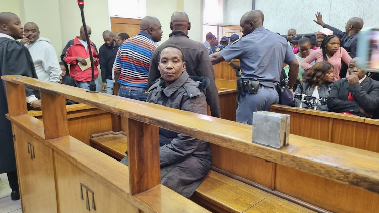 Nqobile Ndlovu cuts a lone figure before her second appearance in Protea magistrate's court for the murders of her grandson, Tshiamo Rabanye, and his friend Nqobizitha Zulu.