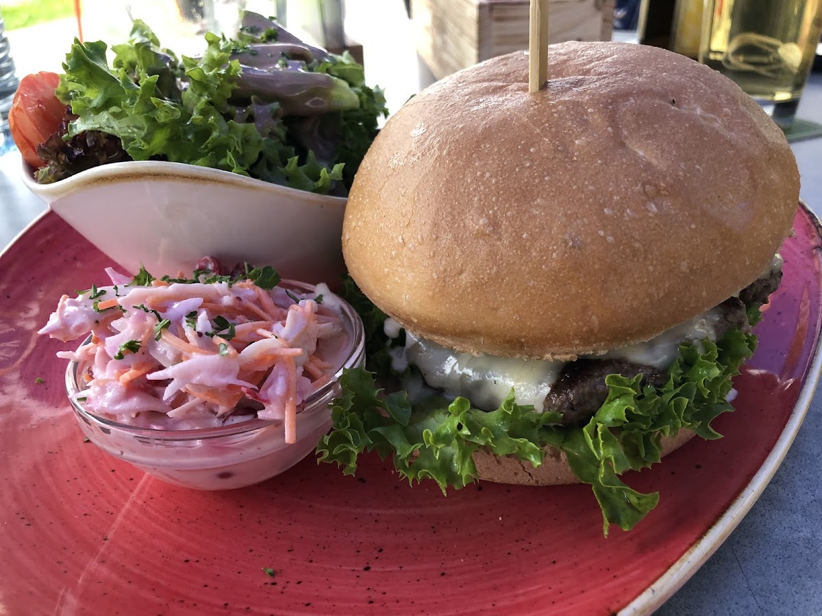 Burger with gouda, relish, and cruspy onions on a gf bun.