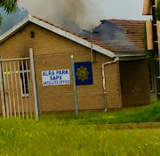 The Alra Park satellite police station was set alight as protesters took to the streets over housing allocations in the area.